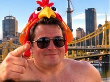 Selfie in the turkey hat in front of the Pittsburgh skyline